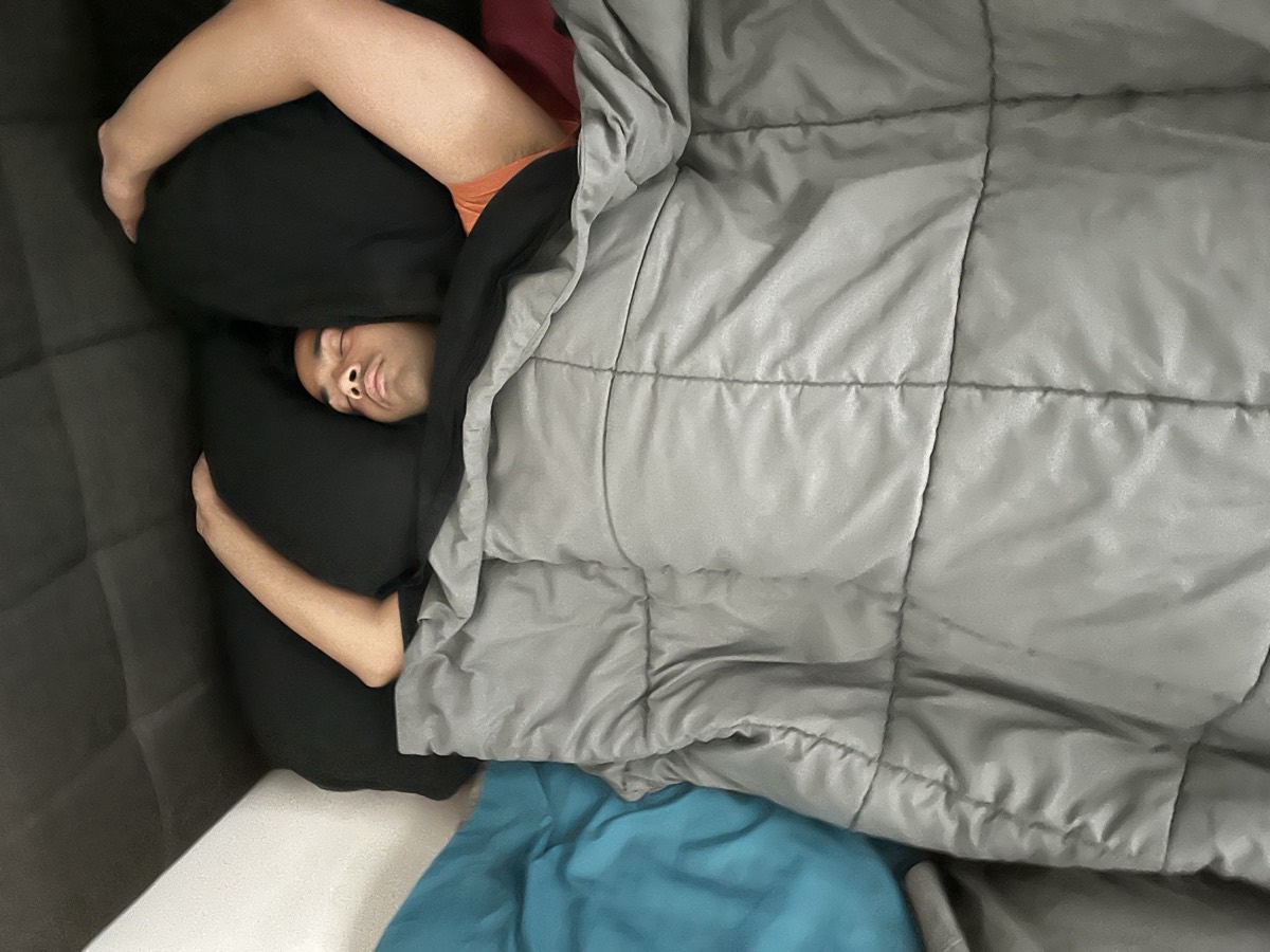 Rohith asleep under a weighted blanket