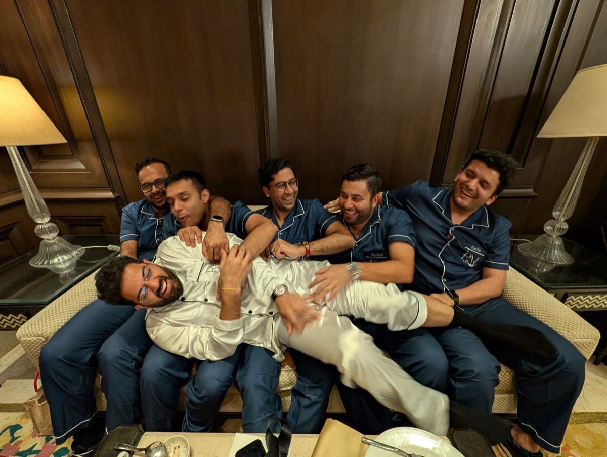 Rohith held down by friends in matching pajamas